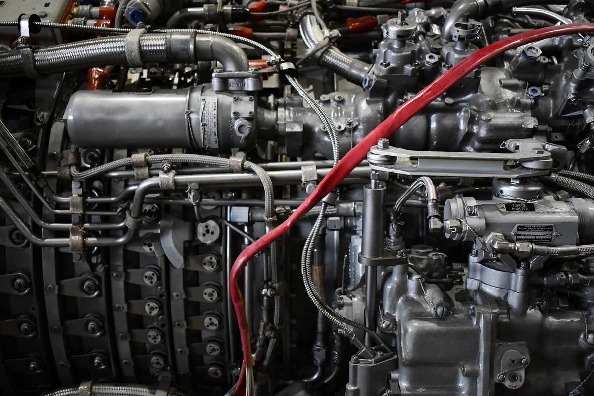 Close-up of the external pipework, fuel components and wiring on a gas turbine engine.
