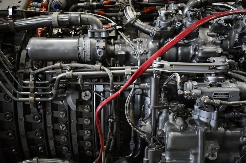 Close-up of the external pipework, fuel components and wiring on a gas turbine engine.