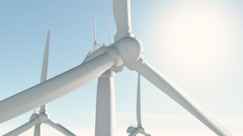 Wind turbines against a clear sky.